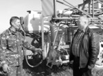 На знімку: селянину у весняну пору не до відпочинку – щойно завершили посівну, а вже роботи ведуться по догляду за озимими. Саме їх проведенням цікавиться директор СТОВ «Лан» Сергій Павлович Савченко у механізатора Петра Івановича Остафійчука, який того дня вносив гербіциди на озимину. Фото Сергія КІСИКА. Фундамент закладено міцний